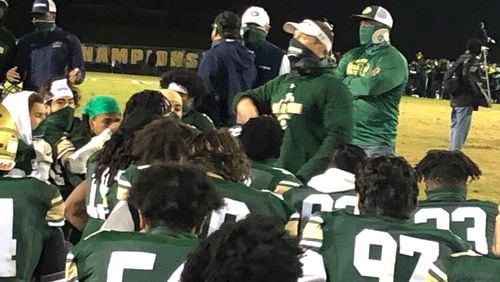 Grayson coach Adam Carter talks to his team after its 30-6 win over Harrison in the Class 7A playoffs.