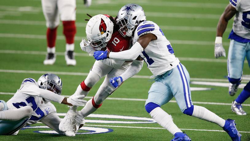 Arizona Cardinals wide receiver DeAndre Hopkins (10) is brought down by Dallas Cowboys cornerback Trevon Diggs (27) and Dallas Cowboys safety Donovan Wilson (37) during the first quarter of play at AT&T Stadium on Monday, Oct. 19, 2020 in Arlington, Texas. (Vernon Bryant/The Dallas Morning News/TNS) 