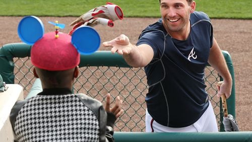 022516 LAKE BUENA VISTA: Braves outfielder Jeff Francoeur tosses his batting gloves to 7-year-old Keion Mathis during spring training at Champion Stadium on Thursday, Feb 25, 2016, at the ESPN Wide World of Sports, Lake Buena Vista, FL.  Curtis Compton / ccompton@ajc.com