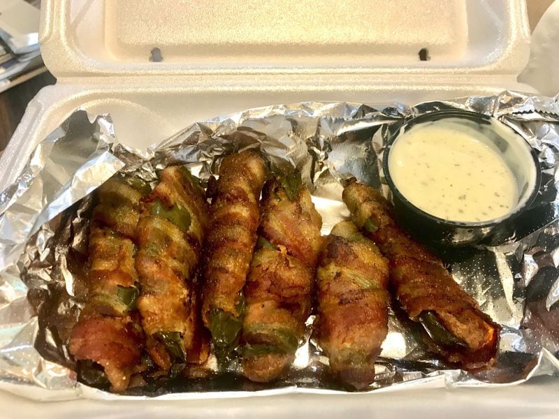 Dining editor Ligaya Figueras highly recommends starting your meal with an order of Bubba Penos. Wrapped in smoked bacon and stuffed with pulled pork, these are some meaty poppers. LIGAYA FIGUERAS / LIGAYA.FIGUERAS@AJC.COM