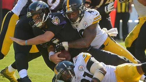 Pittsburgh Steelers linebacker Bud Dupree (48) drills Baltimore Ravens quarterback Joe Flacco while defensive end Stephon Tuitt (below) helps drop him for a nine-yard sack during the fourth quarter on Sunday, Oct. 1, 2017 at M&T Bank Stadium in Baltimore, Md. Pittsburgh prevailed, 26-9, handing Baltimore its second embarrassing defeat. (Karl Merton Ferron/Baltimore Sun/TNS)