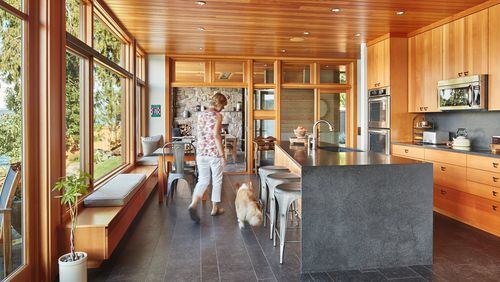 “We struggled with all kinds of ways to deal with eating,” architect Greg Belding says. “In the end, we kept everything simple and gave space for a table” (between the Douglas fir window seats and the trapezoid kitchen island). (Benjamin Benschneider/The Seattle Times/TNS)