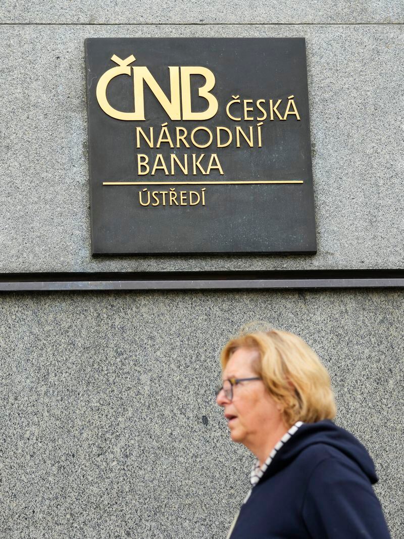 FILE - A woman walks outside the Czech central bank in Prague, Czech Republic, on Nov. 2, 2023. On Thursday May 2, 2024, the Czech Republic's central bank cut its key interest rate for the fourth straight time amid falling inflation and signs of the economy's recovery. The cut by a half-percentage point brought the interest rate down to 5.25%. (AP Photo/Petr David Josek, File)