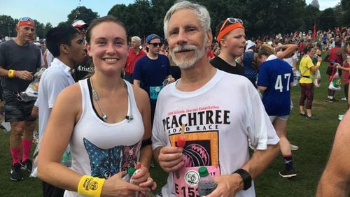 Sarah Stokes and her father, Dwain Cassady, run the 50th AJC Peachtree Road Race on Thursday, their 20th together and Cassady’s 36th.