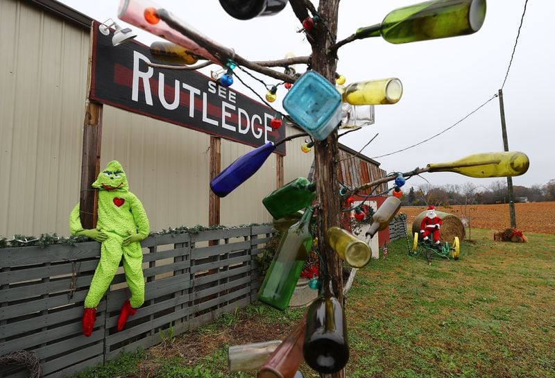 A building that serves as the Rutledge Liquor Store is decorated for Christmas urging passerbys to visit the tiny rural town on Wednesday, Dec 8, 2021.   “Curtis Compton / Curtis.Compton@ajc.com”`