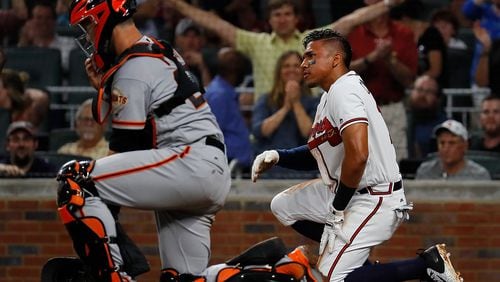 Johan Camargo of the Braves reacts after sliding safely past a mishandled catch by Buster Posey of the San Francisco Giants on a double hit by Ender Inciarte in the third inning at SunTrust Park on June 19, 2017 in Atlanta. (Photo by Kevin C. Cox/Getty Images)