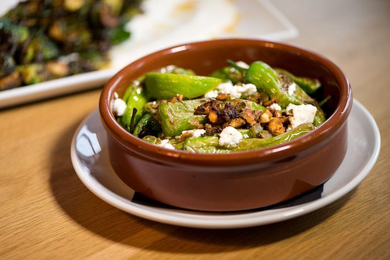  Blistered Shishito Peppers with corn nuts, French feta, minced jalapeno, lime, and cilantro. Photo credit- Mia Yakel.