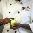 A student peels an apple to make dinner in the kitchen at the Art Institute of Atlanta in 2016. AJC FILE PHOTO