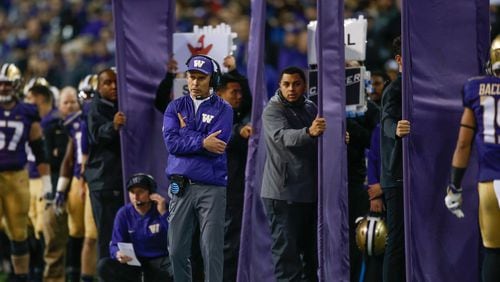 Coach Chris Petersen of the Washington Huskies looks on as assistants behind him hold cloth partitions shielding play signals against the Arizona State Sun Devils on November 19, 2016 at Husky Stadium in Seattle, Washington. The Huskies defeated the Sun Devils 44-18. (Photo by Otto Greule Jr/Getty Images)