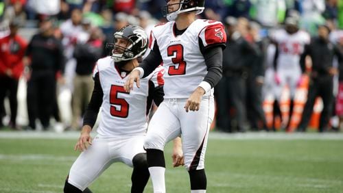 Atlanta Falcons kicker Matt Bryant, right, watches after he kicked a field goal with punter Matt Bosher (5) holding, in the first half of an NFL football game, Sunday, Oct. 16, 2016, in Seattle. (AP Photo/Elaine Thompson)