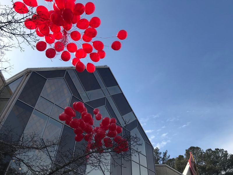  Red balloons were released in Davis' honor after her casket was placed in the hearse. CREDIT: Rodney Ho/rho@ajc.com