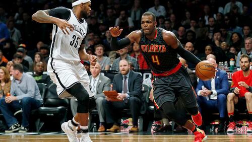 Hawks forward Paul Millsap (4) drives to the basket past Nets forward Trevor Booker (35) during a game Sunday, April 2, 2017, in New York. The Nets won 91-82. (AP Photo/Adam Hunger)