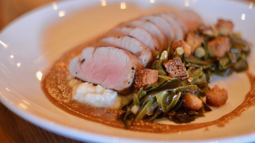 The grilled pork tenderloin, collard greens, toasted cornbread, Anson Mills grits and apple mustard is one of the entree offerings at Kitchen Six. (photo: Henri Hollis for the AJC)