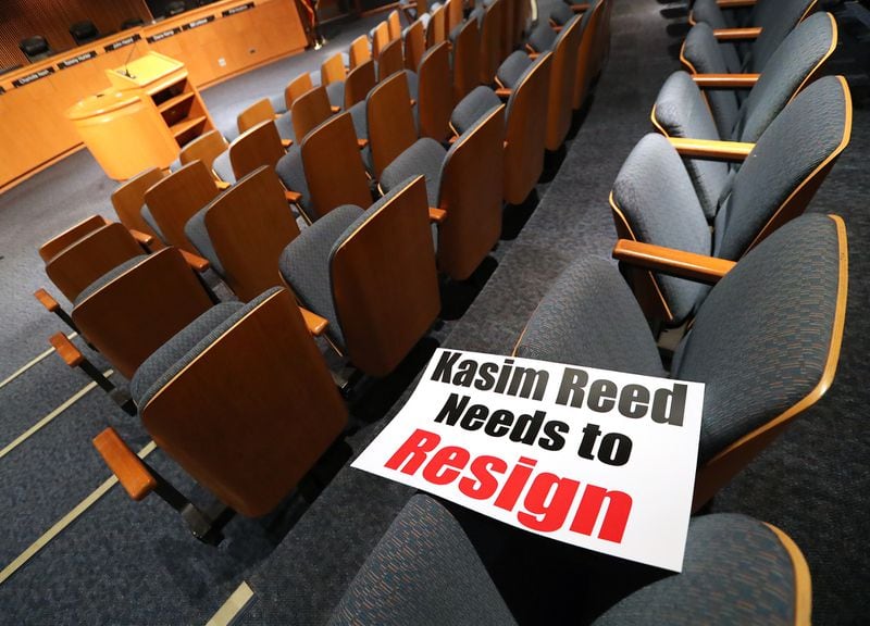 February 28, 2017, Lawrenceville: Signs have been set out calling for Atlanta Mayor Kasim Reed to resign at the Gwinnett County Board of Commissioners public hearing session before it begins on Tuesday Feb. 28, 2017, in Lawrenceville. Atlanta Mayor Kasim Reed contacted United Consulting, a city vendor that also employs embattled Gwinnett County Commissioner Tommy Hunter. Reed sent a threatening letter to the Norcross-based engineering firm, denouncing the content of Hunters now infamous Jan. 14 Facebook post  in which he called civil rights leader and U.S. Rep. John Lewis a racist pig  asking how the company planned to resolve this matter.    Curtis Compton/ccompton@ajc.com