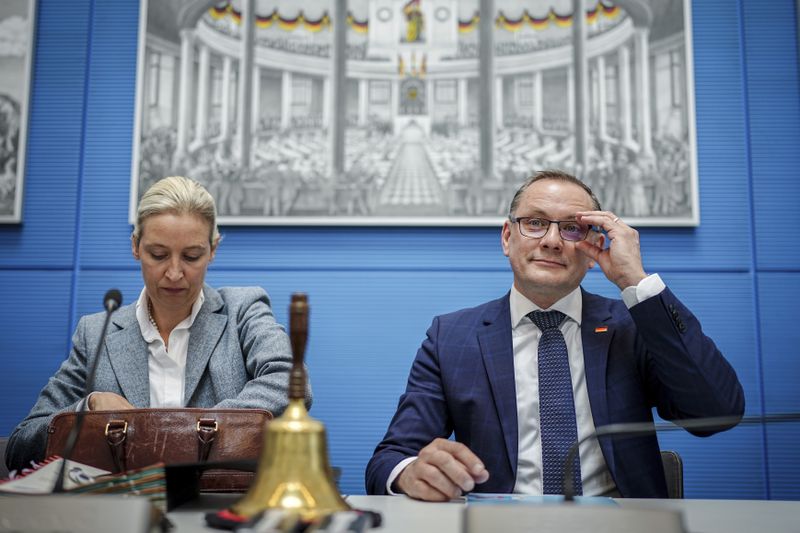 leader of the AfD parliamentary group Alice Weidel, left, and AfD federal chairman and leader of the AfD parliamentary group Tino Chrupalla take part in the meeting of their parliamentary group in Berlin, Germany, Tuesday April 23, 2024. (Kay Nietfeld/dpa via AP)
