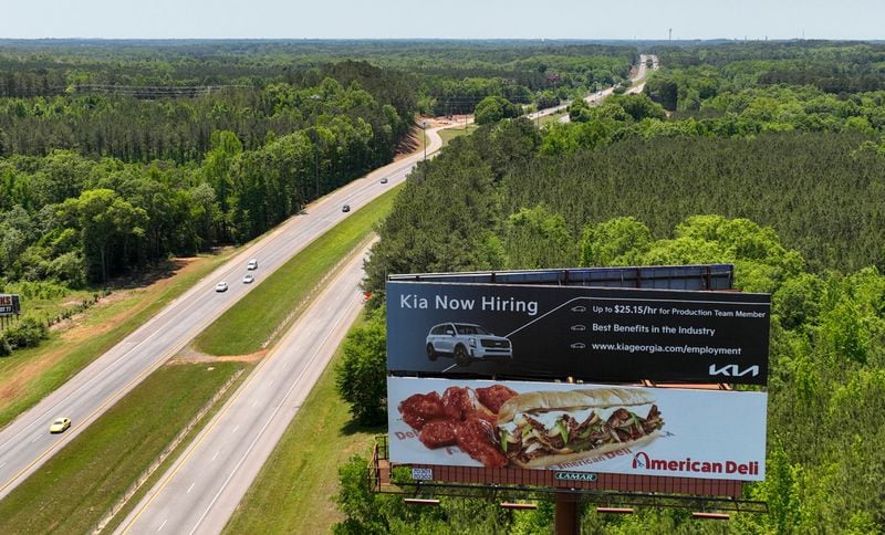 Kia's hiring billboard is displayed along I-85 in West Point on Wednesday, May 11, 2022. Georgia is poised to announce its second electric vehicle plant, a massive assembly complex by Hyundai Motor Group, that could bring with it 8,500 jobs to a site near Savannah, people familiar with the matter have told The Atlanta Journal-Constitution.  (Hyosub Shin / Hyosub.Shin@ajc.com)