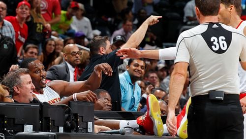 Dwight Howard of the Hawks reacts after diving across the scorer’s table while chasing a loose ball against the New Orleans Pelicans at Philips Arena on October 18, 2016 in Atlanta, Georgia. Photo by Kevin C. Cox/Getty Images)