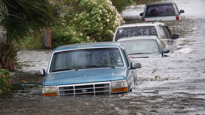 GALVESTON, TX - SEPTEMBER 12: Vehicles flooded by the tidal surge from Hurricane Ike sit along a street September 12, 2008 in Galveston, Texas. The eye of the hurricane is expected to make landfall at Galveston Island early Saturday morning. (Photo by Scott Olson/Getty Images)