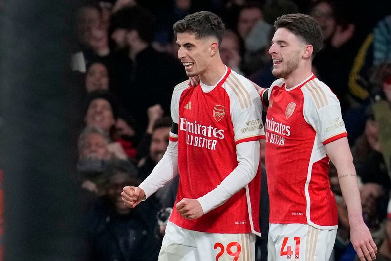 Arsenal's Kai Havertz, left, celebrates with Arsenal's Declan Rice after scoring his side's third goal during the English Premier League soccer match between Arsenal and Chelsea at Emirates Stadium in London, Tuesday, April 23, 2024. (AP Photo/Kin Cheung)