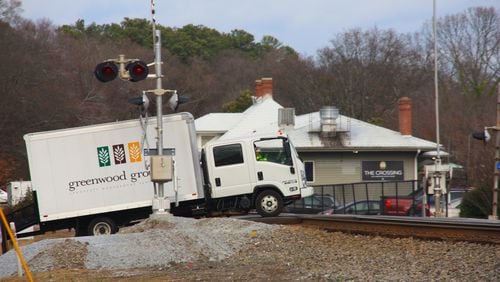 Steep incline at this railroad intersection in downtown Norcross has resulted in numerous vehicles stuck on the tracks, two in recent years resulted in train collisions. Photo by Karen Huppertz for the AJC