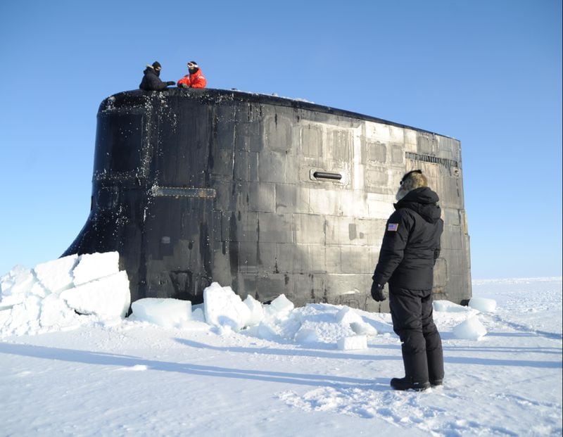 BEAUFORT SEA (March 21, 2018) Hector Castillo, a U.S. Navy Arctic Submarine Laboratory technician, speaks with crewmembers aboard the Seawolf-class fast-attack submarine USS Connecticut (SSN 22) after it surfaced through the ice during the multinational maritime Ice Exercise (ICEX) in the Arctic Circle. ICEX 2018 is a five-week exercise that allows the Navy to assess its operational readiness in the Arctic, increase experience in the region, advance understanding of the Arctic environment, and continue to develop relationships with other services, allies and partner organizations. (U.S. Navy photo by Chief Darryl I. Wood/Released)