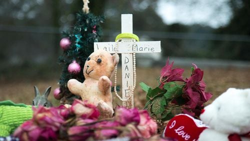 A cross, toys and Christmas decorations cover the grave of 2-year-old Laila Marie Daniel in Berea Cemetery, Thursday, Jan. 21, 2016, in Hampton, Ga. A bill moving in the state Legislature could shield certain information about child deaths from disclosure. BRANDEN CAMP/SPECIAL