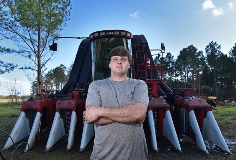 Farmer Reese Foster in front of his cotton picker at his home in Dawson in 2019. With peanuts still on the ground, Foster is hoping to break even this year. HYOSUB SHIN / HSHIN@AJC.COM