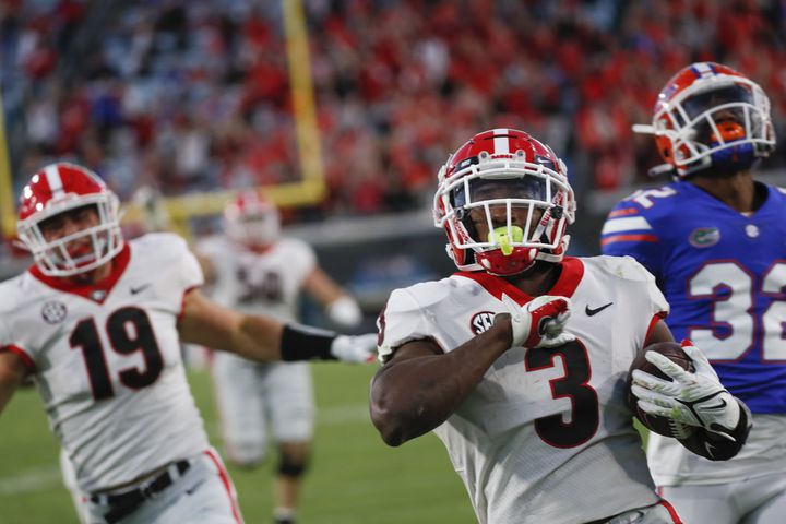 10/30/21 - Jacksonville -  Georgia Bulldogs running back Zamir White (3) scores on this 4th quarter touchdown run during the second half of the annual NCCA  Georgia vs Florida game at TIAA Bank Field in Jacksonville. Georgia won 34-7.  Bob Andres / bandres@ajc.com
