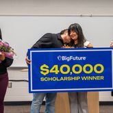 Yadhira Alvarado-Zarate, a junior at Duluth’s McClure Health Science High School, is congratulated by her dad during a ceremony to award her with a $40,000 scholarship from BigFuture on Jan. 19, 2024, in Gwinnett County. (Jamie Spaar for The Atlanta Journal-Constitution)