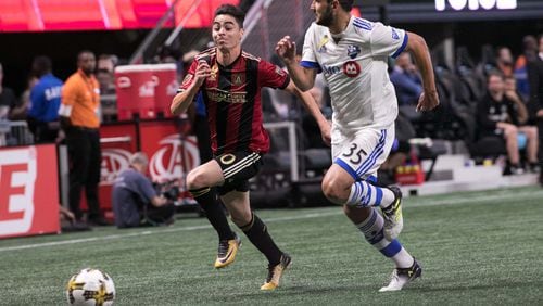 Atlanta United midfielder Miguel Almiron (10) pushes the ball past Montreal Impact defender Deian Boldor (35) during the first half of a MLS soccer game at Mercedes-Benz Stadium, Sunday, Sept. 24, 2017, in Atlanta.  BRANDEN CAMP/SPECIAL