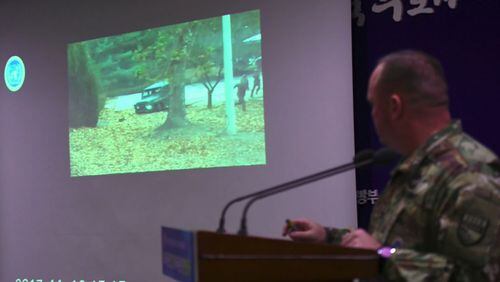 United Nations Command spokesman Colonel Chad G. Carroll shows a surveillance TV footage containing the moment of defection of a North Korean soldier.