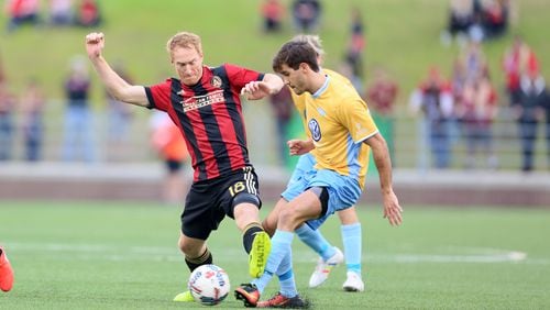 Midfielder Jeff Larentowicz (18) makes a tackle in Saturday’s game against Chatttanooga. (Miguel Martinez)
