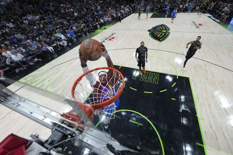 Oklahoma City Thunder guard Shai Gilgeous-Alexander (2) slam dunks in the first half of Game 4 of an NBA basketball first-round playoff series against the New Orleans Pelicans in New Orleans, Monday, April 29, 2024. (AP Photo/Gerald Herbert)