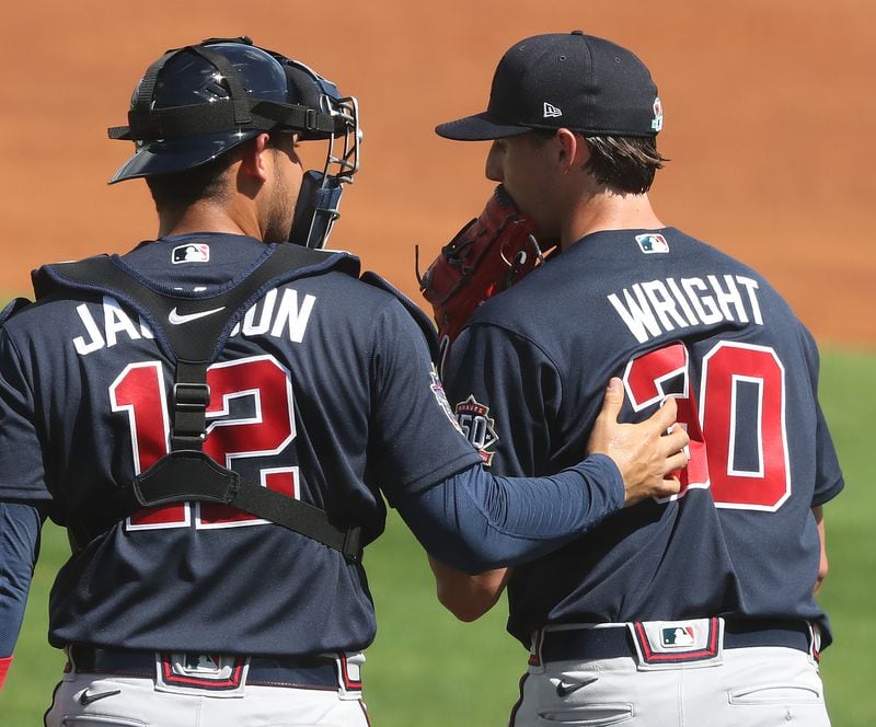 Atlanta Braves starting pitcher Kyle Wright confers with catcher Alex Jackson after giving up a run to the Tampa Bay Rays during the second inning Sunday, Feb. 28, 2021, at Charlotte Sports Park in Port Charlotte, Fla. (Curtis Compton / Curtis.Compton@ajc.com)