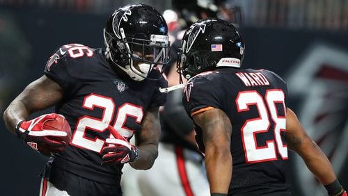Falcons running back Tevin Coleman celebrates his second touchdown run with Terron Ward to take a 34-20 lead over the Buccaneers Sunday, Nov. 26, 2017, in Atlanta.