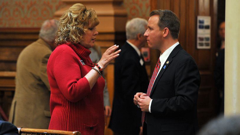 Sen. Renee Unterman, R-Buford, talks with Sen. John Albers, R-Woodstock, during the February 4, 2014, Legislative session. Unterman, along with five other lawmakers, introduced S.B. 350 which calls for privatizing Georgia's child protection system.