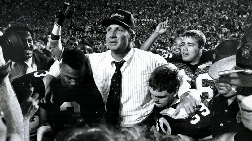 Auburn University's Pat Dye is carried off the field after a win of the University of Alabama. (Louie Favorite/AJC staff) 1987
