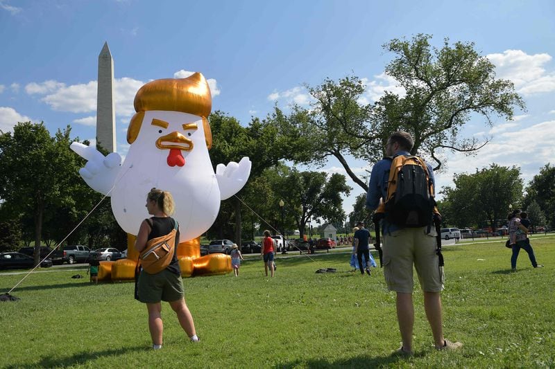 An inflatable chicken mimicking US President Donald Trump is set up on The Ellipse, a 52-acre (21-hectare) park located just south of the White House and north of the Washington Monument (rear).