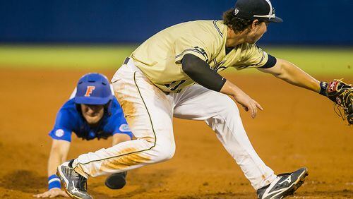 Florida's Jonathan India tries to make it back to first before the tag but Georgia Tech's Tristin English (foreground) makes the play Sunday, June 5, 2016 in Gainesville, Fla.