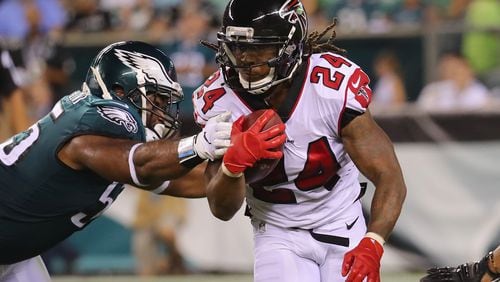 Devonta Freeman of the Atlanta Falcons is tackled by Brandon Graham  of the Philadelphia Eagles during the first half at Lincoln Financial Field on September 6, 2018 in Philadelphia, Pennsylvania.  (Photo by Brett Carlsen/Getty Images)