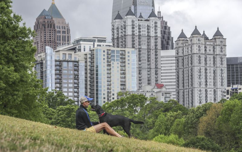 File photo of Ron Hoffman enjoying Piedmont Park in midtown with his black Labrador Retriever, Georgia. (John Spink / John.Spink@ajc.com)


