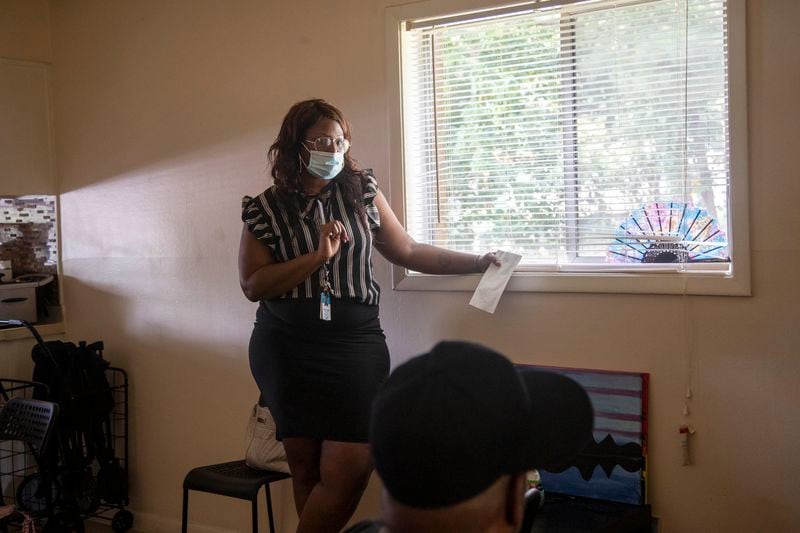 Atlanta Policing Alternatives and Diversion Initiative Housing Coordinator Christina Lazare conducts a community meeting at Antonio Bryant’s residence in Morrow, Thursday, Aug. 12, 2021.  (Alyssa Pointer/Atlanta Journal Constitution)