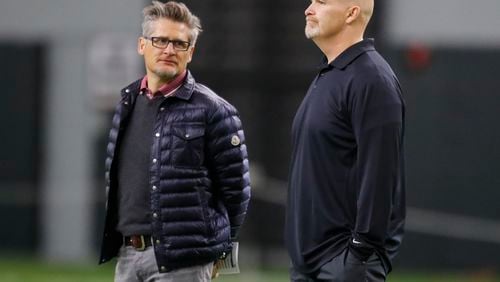 Atlanta Falcons head coach Dan Quinn, right, and general manager Thomas Dimitroff watch during Georgia Pro Day, Wednesday, March 21, 2018, in Athens. Pro Day is intended to showcase talent to NFL scouts for the upcoming draft. (AP Photo/Todd Kirkland)