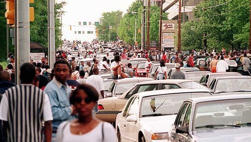 Freaknik revelers bring Lenox Road traffic to a standstill after Lenox Square and Phipps Plaza malls closed early on a Saturday in 1995.