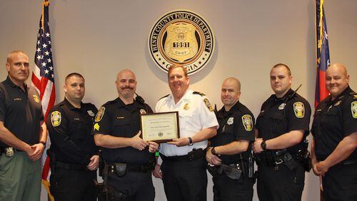 Pictured from left are Deputy Chief Mark Amerman, Officer Kelly Horne, Sergeant Scott Cumbie, Police Chief Keith Nichols, Officer Jason Jones, Officer Kenneth Palmer and Captain Scott Gray.