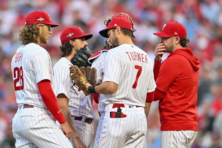 The Philadelphia Phillies surround starting pitcher Aaron Nola (27) during a mound conference after the Atlanta Braves scored in the third inning of NLDS Game 3 in Philadelphia on Wednesday, Oct. 11, 2023.   (Hyosub Shin / Hyosub.Shin@ajc.com)