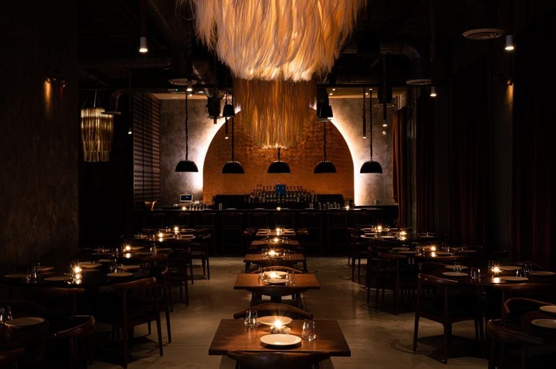 A dramatically lit bar and modern chandeliers are focal points of the Palo Santo dining room. Courtesy of the Cocktail Shaker