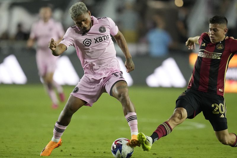 Inter Miami forward Josef Martínez (17) and Atlanta United midfielder Matheus Rossetto (20) go after the ball during the first half of a Leagues Cup soccer match, Tuesday, July 25, 2023, in Fort Lauderdale, Fla. (AP Photo/Rebecca Blackwell)