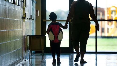 170816 TAYLOR, TEXAS:  Renee Long accompanies her son Jakevin Brown, 4, to his pre-k classroom on Wednesday, the first day of classes at T.H. Johnson Elementary School in Taylor.  T.H. Johnson Elementary School, with approximately 375 students, is for pre-k and kindergarten students in Taylor.  Andy Sharp / For the American-Statesman.