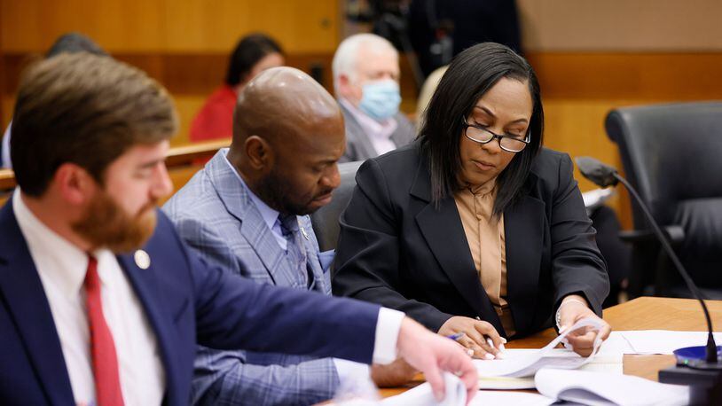 Fulton County District Attorney Fani Willis (right) interacts with colleagues Donald Wakeford (left) and Nathan Wade (center) during a hearing on Jan. 24, 2023. (Miguel Martinez/Atlanta Journal-Constitution/TNS)